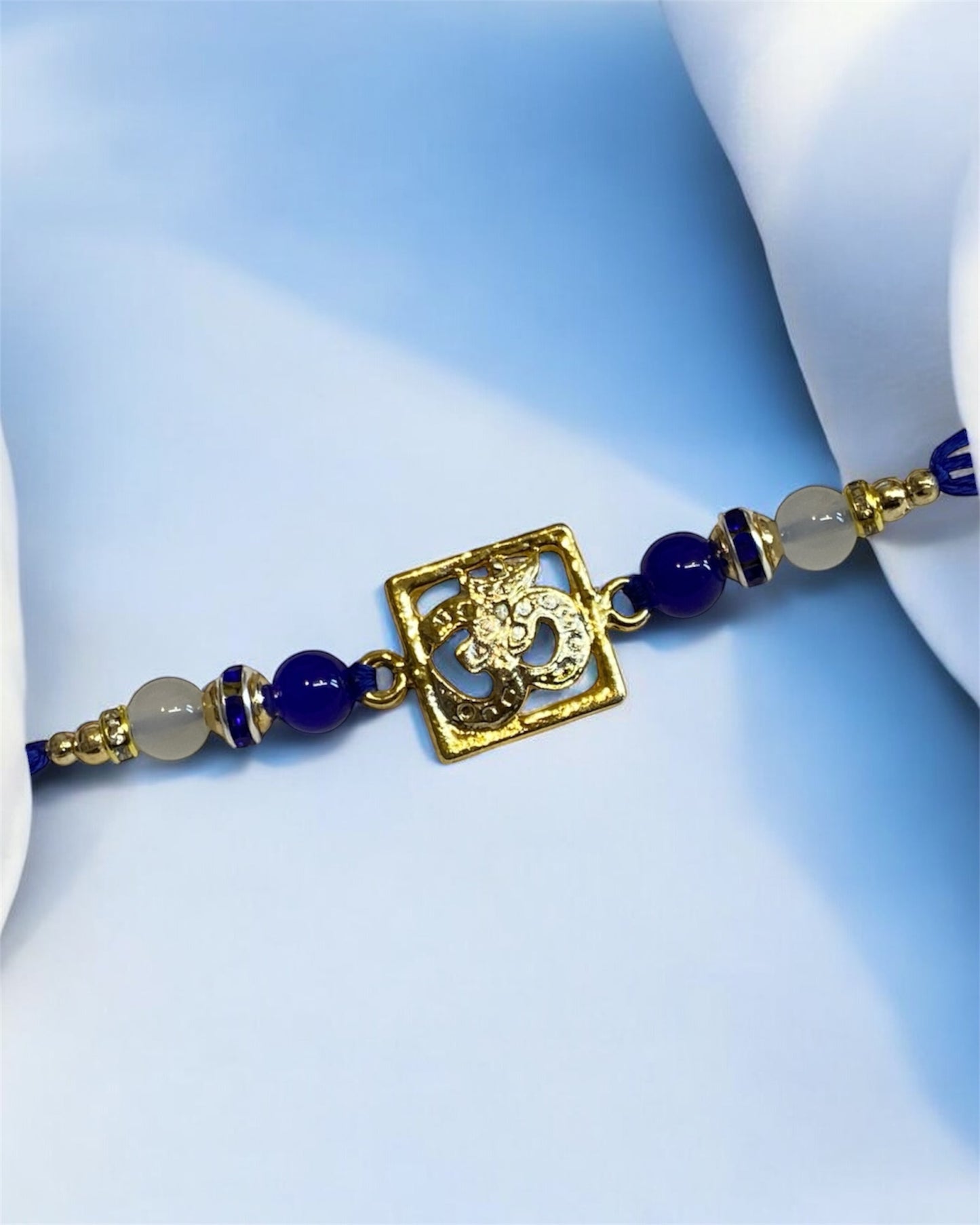 Fancy Designer Rakhi for Brother – Om Beaded Thread Bracelet Rakhi 2025 | UK Rakhi Supplier