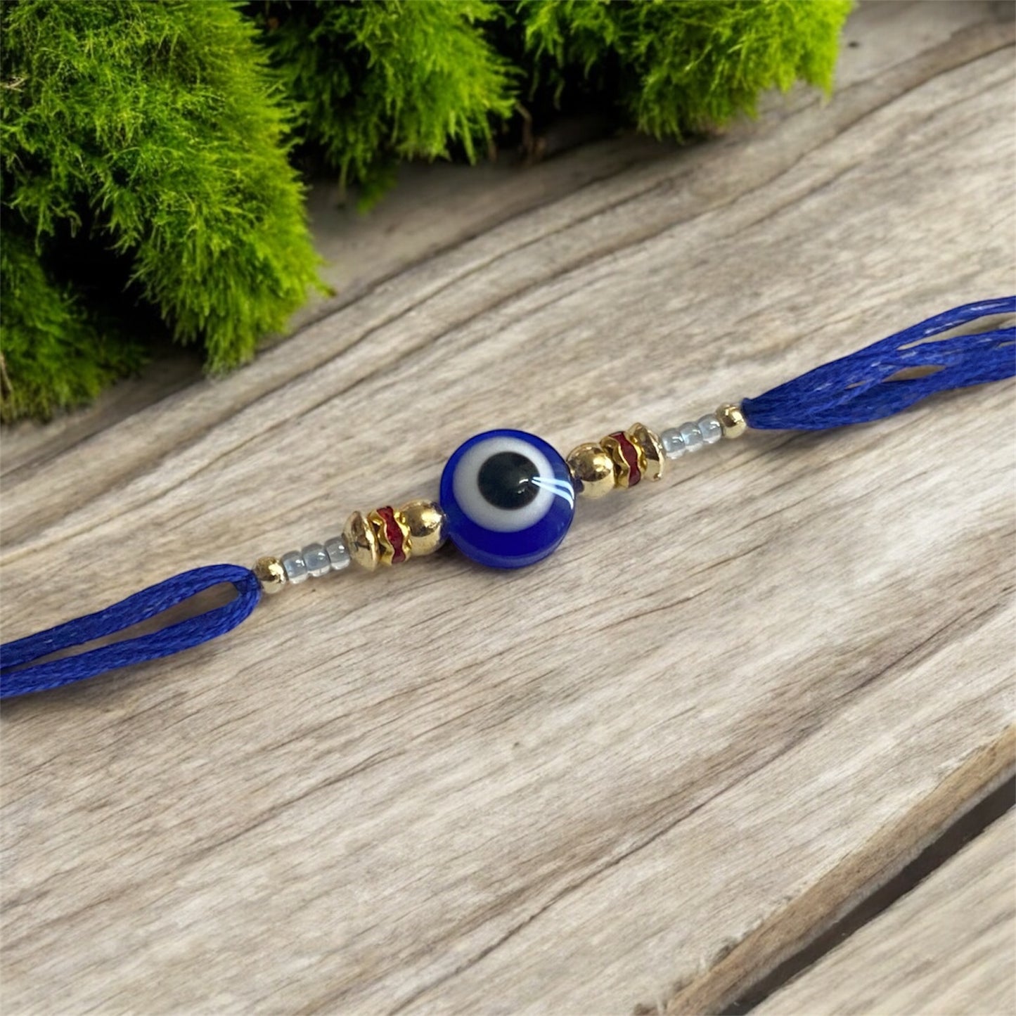 Royal Blue Evil Eye Rakhi with Gold Beads & Rhinestone Accents – Rakhi for Brother | Handmade Rakhi UK