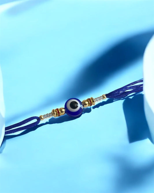 Royal Blue Evil Eye Rakhi with Gold Beads & Rhinestone Accents – Rakhi for Brother | Handmade Rakhi UK